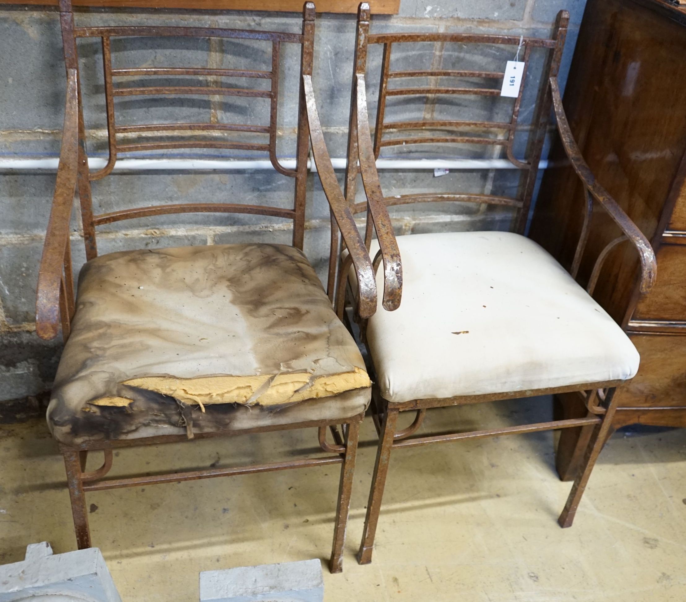 A pair of wrought iron designer chairs